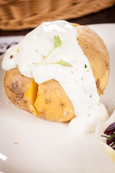 fresh foilpotato from the oven with herb quark sour cream and fresh herbs