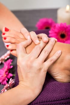 Woman with pedicure in a beauty salon on a towel with lactated toe nails