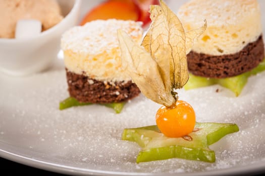 Brownie chocolate brownie with ice cream and plums prepared on a plate