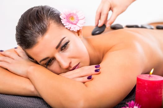 young woman relaxes during a back massage at salon wellness spa health therapy