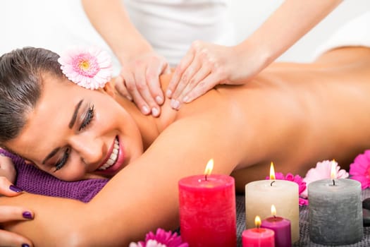 young woman relaxes during a back massage at salon wellness spa health therapy