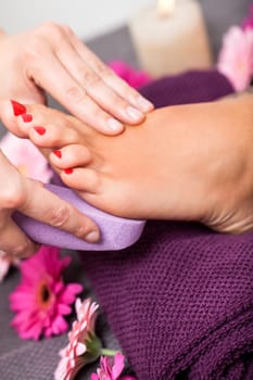 Woman with pedicure in a beauty salon on a towel with lactated toe nails