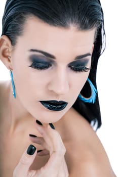 attractive young woman with black hair blue eyes and black makeup lips nail polish portrait