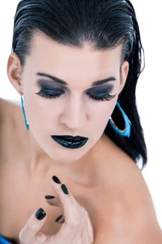attractive young woman with black hair blue eyes and black makeup lips nail polish portrait
