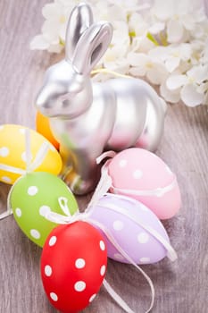 Colourful yellow and red Tulip with Easter eggs decorated at Easter with text space on green background
