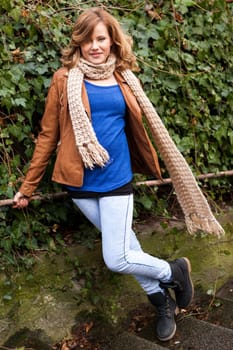 Pretty young woman teen on a road with vehicles outdoors in autumn