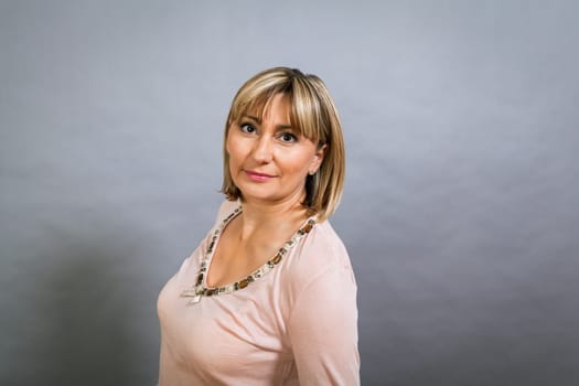 adult attractive woman in middle age portrait against gauem background