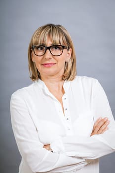 attractive adult woman in middle age with white blouse and brille