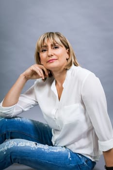 adult attractive woman in middle age portrait against gauem background