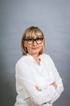 attractive adult woman in middle age with white blouse and brille