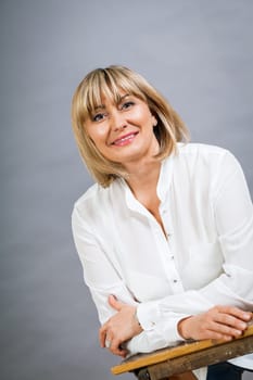 adult attractive woman in middle age portrait against gauem background