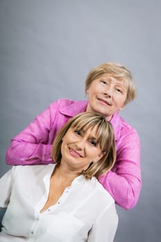 older adult happy wife mother with adult daughter portrait generation against grey background