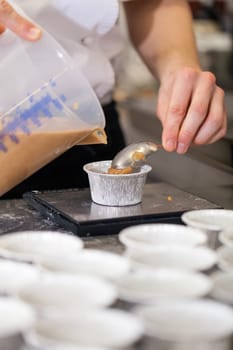 chef solves freshly baked tarts from the mould in the kitchen restaurant pastry shop