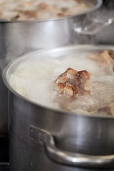gastronomy restaurant kitchen with hob and steaming pots while cooking to prepare dinner dinner