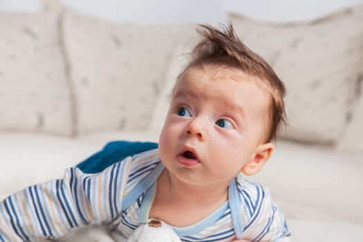 Studio portrait of a happy 3 months old baby boy at home.
