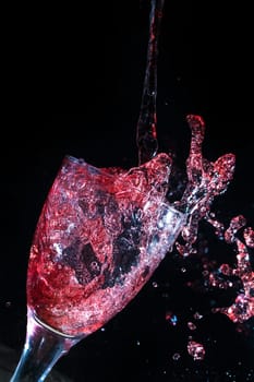 Wine pouring into a glass frozen