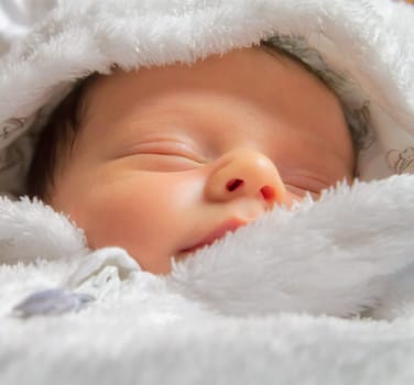 Closeup portrait of newborn baby boy sleeping.