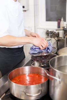 gastronomy restaurant kitchen with hob and steaming pots while cooking to prepare dinner dinner