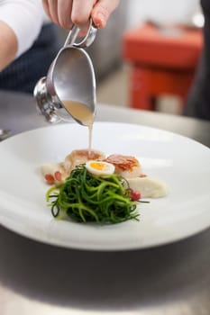 gourmet food with scallops and quail eggs and puree prepared with sauce