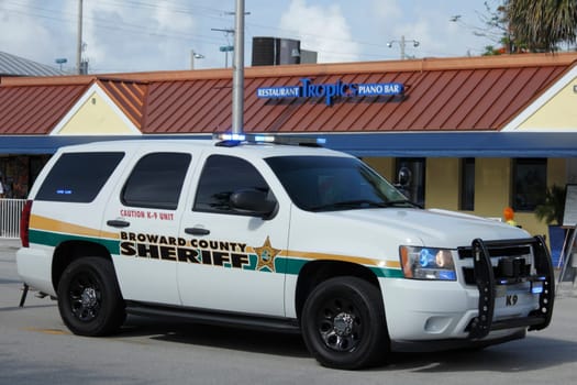 WILTON MANORS, FLORIDA - JUNE 23, 2013: Large white Broward County Sheriff K-9 truck with its lights on parked at entrance to second day of Stonewall Summer Pride on Wilton Drive at NE 20th Street.
