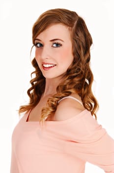 A closeup portrait picture of a young pretty teenager with long curly hair.in a pink blouse and blue eyes, for white background..
