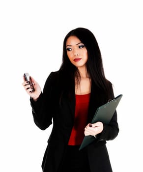 A lovely Asian business woman looking at her cell phone, holding a.folder in her hands for white background..