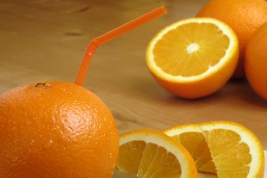 Orange with drinking straw