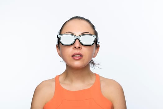 Portrait of beautiful caucasian woman wearing large 3D cinema glasses looking enthralled