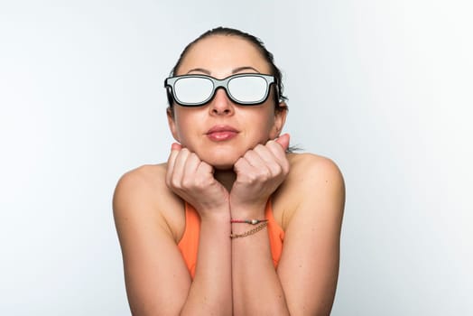 Portrait of beautiful caucasian woman wearing large 3D cinema glasses looking enthralled