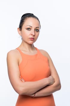 Portrait of beautiful caucasian woman wearing orange dress and looking serious