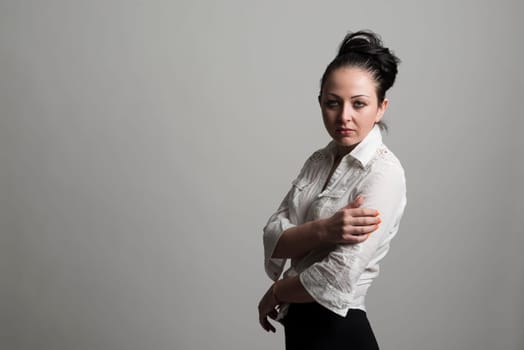 Fashion portrait of beautiful caucasian female model wearing white shirt