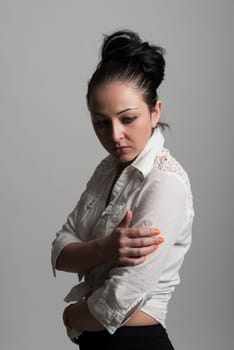 Fashion portrait of beautiful caucasian female model wearing white shirt