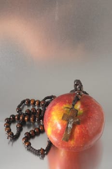 Bible Eva's Sin Red Apple over a Colored Background