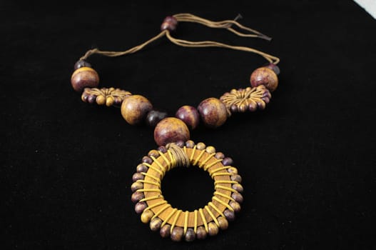 Handmade Wood Collar Necklace on a Black Background