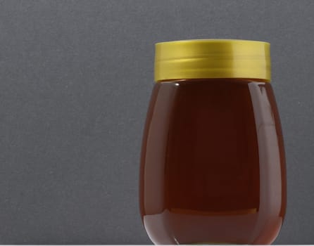 One Full Honey Jar on a Colored Background