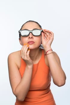Portrait of beautiful caucasian woman wearing large 3D cinema glasses looking enthralled