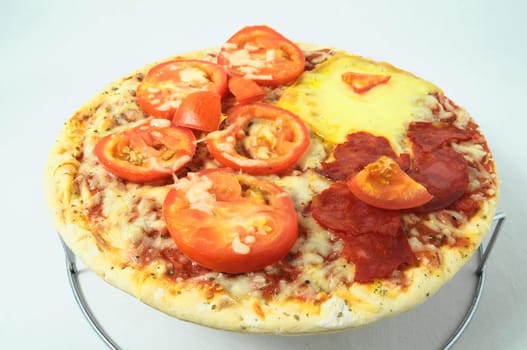 Cooked Mixed Italian Pizza over a White Background