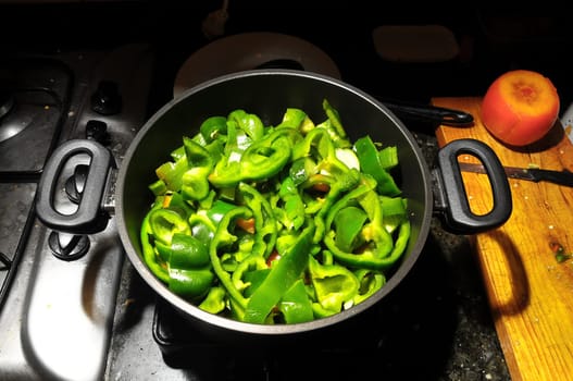 Coocking Green Chili Pepperson a Black Pot