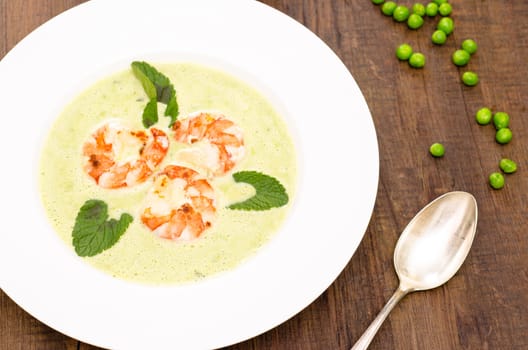 Plate of pea soup,shrimp and mint