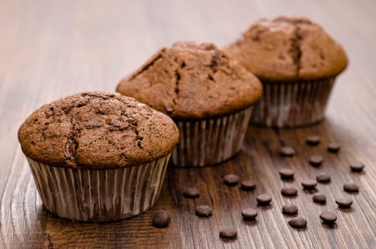 Close-up chocolate muffins on a brown table