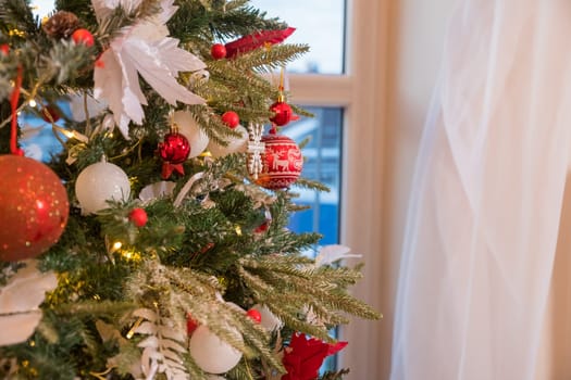 Christmas decorations on the branches fir,Decorated Christmas tree on blurred, sparkling and fairy background