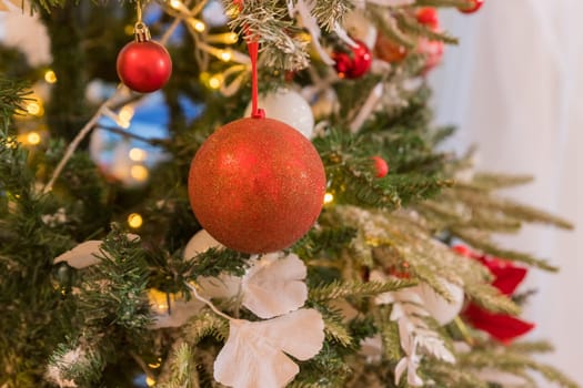 Christmas decorations on the branches fir,Decorated Christmas tree on blurred, sparkling and fairy background