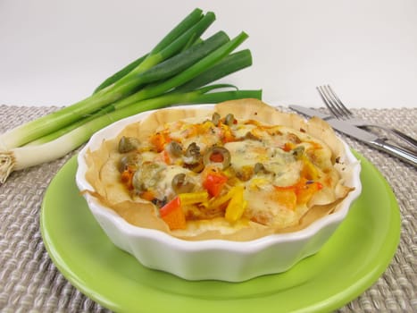 Small quiche with vegetables in a tart form