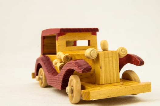 Wooden Toy Red and Yellow Car on a white Backgraund