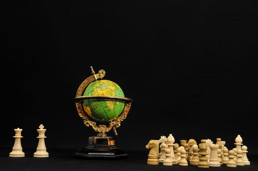 Globe And White Chess on a Black Background