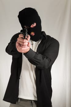 Black Dressed Young Man Holding a Pistol Gun