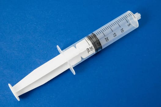 Big Black and White Syringe on a Colored Background