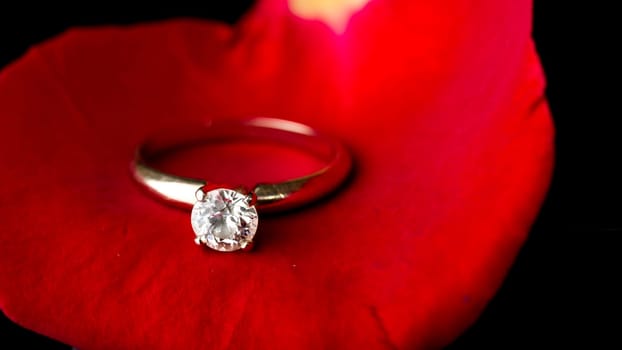 The perfect Valentine's Day gift, an engagement ring on a red rose