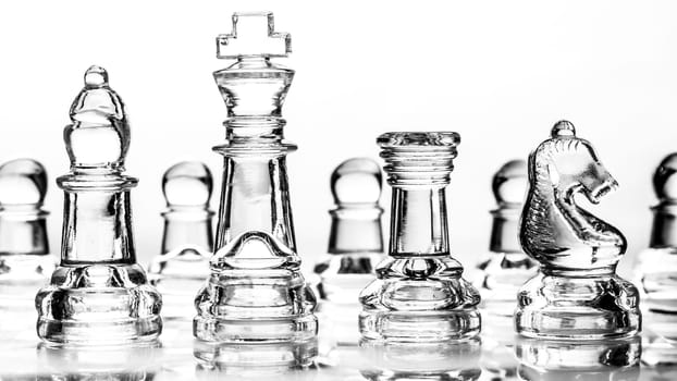 bishop, king, rook and knight chess pieces made out of glass