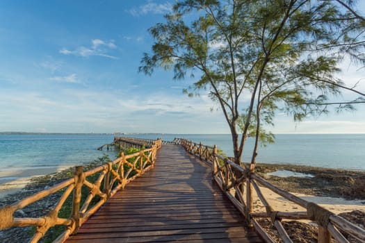 An old wooden pier on the Indian ocean built on the shores of Prison Island in Zanzibar, Tanzania